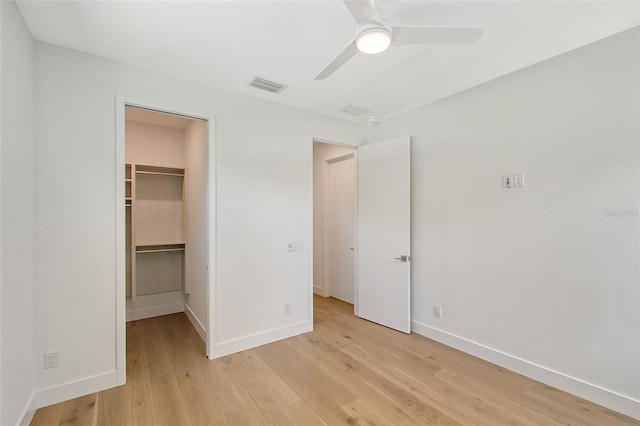 7200 Chameleon Way, Sarasota, FL 34241 - unfurnished bedroom with light wood-type flooring, a spacious closet, baseboards, and a closet