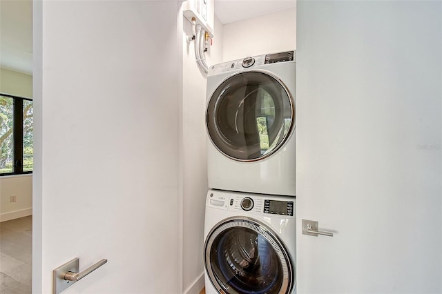 7200 Chameleon Way, Sarasota, FL 34241 - clothes washing area with estacked washer and dryer, baseboards, and wood finished floors