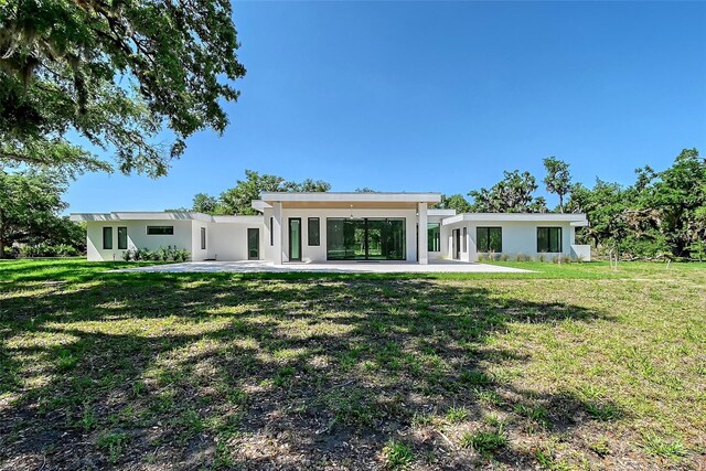 7200 Chameleon Way, Sarasota, FL 34241 - rear view of house featuring stucco siding, a yard, and a patio area