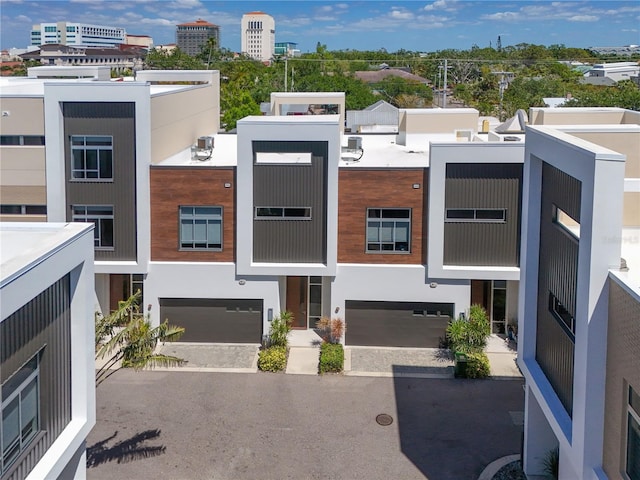 221 Cosmopolitan Ct, Sarasota, FL 34236 - exterior space featuring stucco siding, an attached garage, and driveway