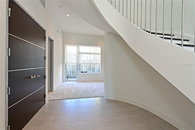 221 Cosmopolitan Ct, Sarasota, FL 34236 - foyer featuring light carpet, baseboards, recessed lighting, and light tile patterned flooring
