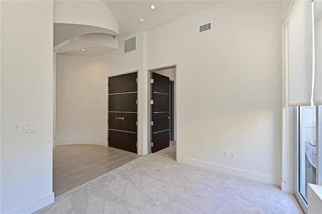 221 Cosmopolitan Ct, Sarasota, FL 34236 - unfurnished room with arched walkways, carpet flooring, visible vents, and baseboards
