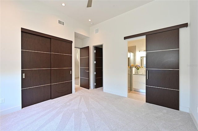 221 Cosmopolitan Ct, Sarasota, FL 34236 - unfurnished bedroom with a closet, visible vents, light colored carpet, and connected bathroom
