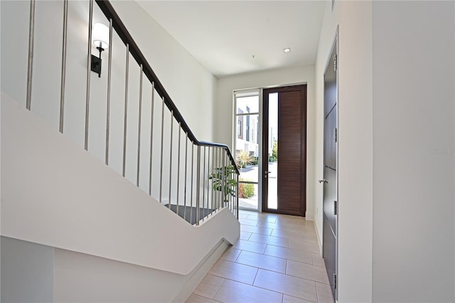 221 Cosmopolitan Ct, Sarasota, FL 34236 - entrance foyer featuring stairway and light tile patterned flooring