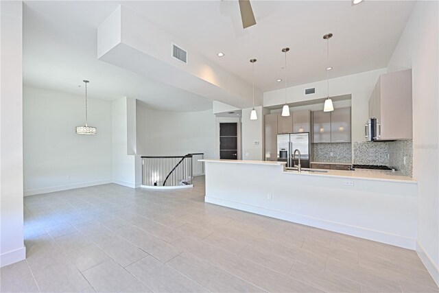 221 Cosmopolitan Ct, Sarasota, FL 34236 - kitchen featuring a sink, visible vents, backsplash, light countertops, and appliances with stainless steel finishes