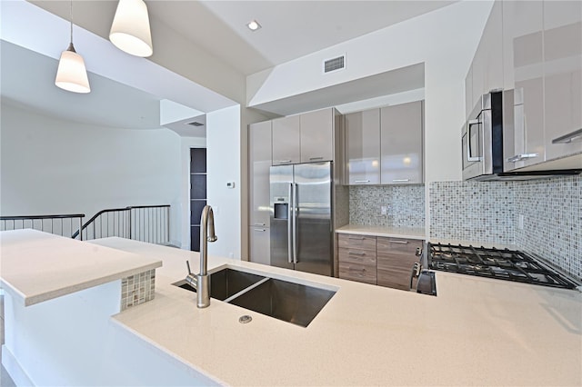 221 Cosmopolitan Ct, Sarasota, FL 34236 - kitchen with a sink, visible vents, backsplash, modern cabinets, and appliances with stainless steel finishes