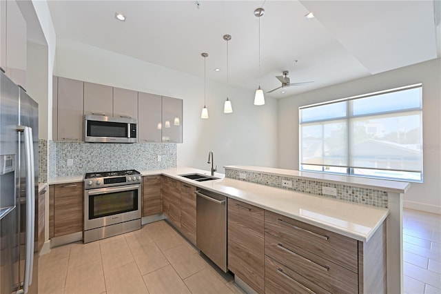 221 Cosmopolitan Ct, Sarasota, FL 34236 - kitchen featuring a sink, brown cabinets, modern cabinets, stainless steel appliances, and a peninsula
