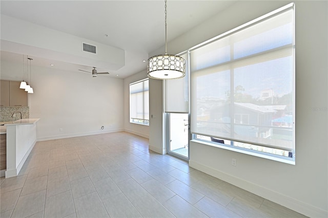 221 Cosmopolitan Ct, Sarasota, FL 34236 - unfurnished dining area featuring visible vents, baseboards, ceiling fan, and a sink