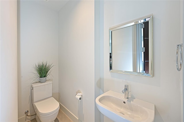 221 Cosmopolitan Ct, Sarasota, FL 34236 - half bathroom with toilet, baseboards, and a sink