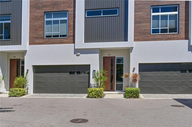 221 Cosmopolitan Ct, Sarasota, FL 34236 - view of front of house featuring an attached garage and stucco siding