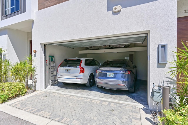 221 Cosmopolitan Ct, Sarasota, FL 34236 - view of parking with decorative driveway and a garage