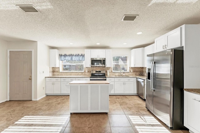 2151 Upton Ave, Sarasota, FL 34232 - kitchen featuring a sink, appliances with stainless steel finishes, backsplash, and visible vents