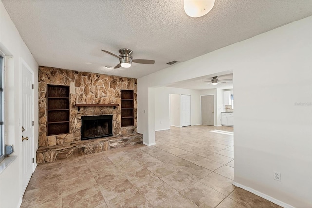2151 Upton Ave, Sarasota, FL 34232 - unfurnished living room featuring visible vents, a fireplace, baseboards, ceiling fan, and a textured ceiling