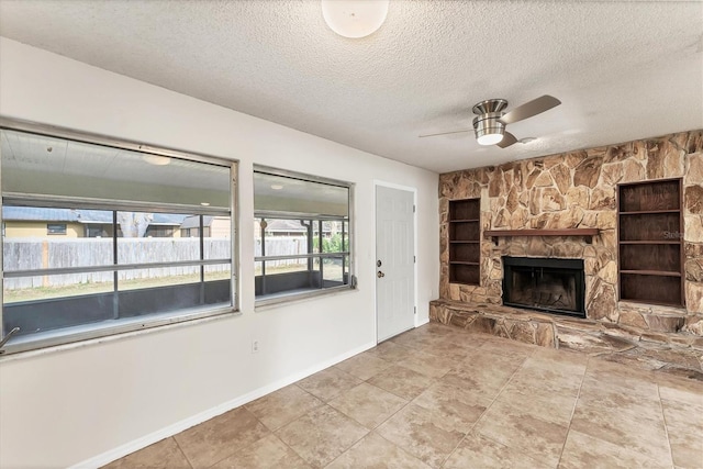 2151 Upton Ave, Sarasota, FL 34232 - unfurnished living room with ceiling fan, a textured ceiling, built in features, a fireplace, and baseboards
