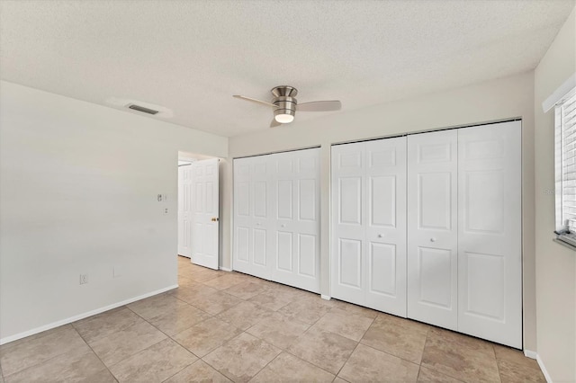 2151 Upton Ave, Sarasota, FL 34232 - unfurnished bedroom featuring multiple closets, baseboards, a textured ceiling, and visible vents