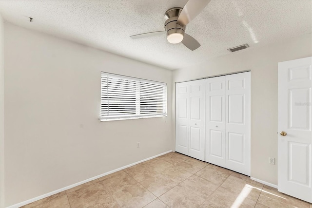 2151 Upton Ave, Sarasota, FL 34232 - unfurnished bedroom with baseboards, a closet, a textured ceiling, and visible vents