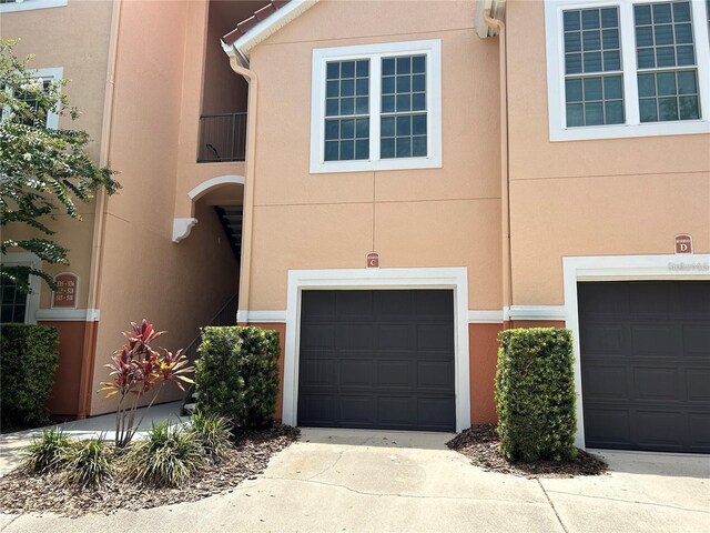 4166 Central Sarasota Pkwy Unit 535, Sarasota, FL 34238 - view of front facade with driveway, a garage, and stucco siding