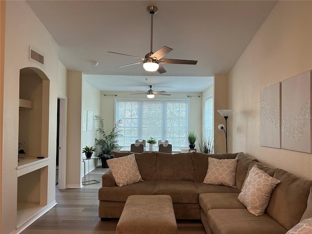 4166 Central Sarasota Pkwy Unit 535, Sarasota, FL 34238 - living room featuring baseboards, visible vents, ceiling fan, arched walkways, and wood finished floors