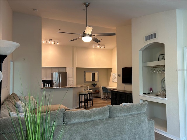 4166 Central Sarasota Pkwy Unit 535, Sarasota, FL 34238 - living room featuring visible vents, track lighting, ceiling fan, wood finished floors, and a towering ceiling