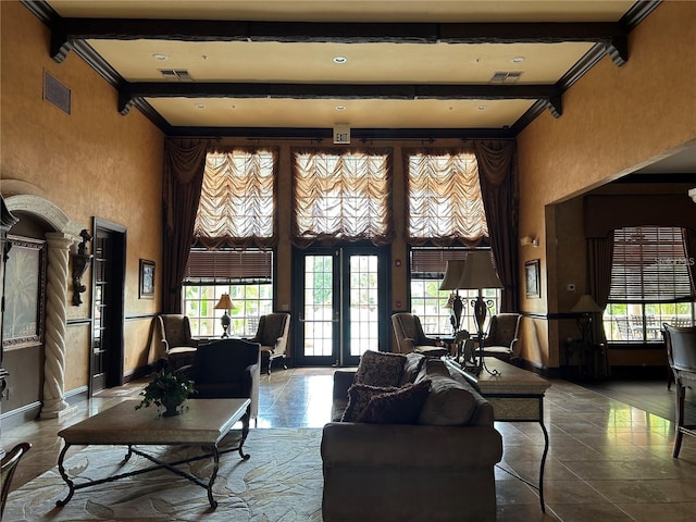4166 Central Sarasota Pkwy Unit 535, Sarasota, FL 34238 - living room featuring beamed ceiling, a towering ceiling, and visible vents