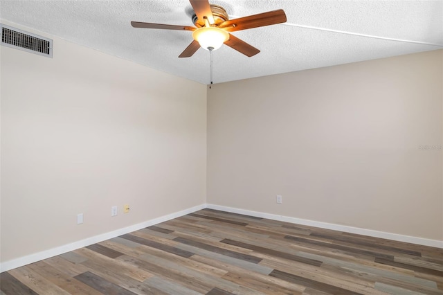 4885 1st St NE Unit 308, Saint Petersburg, FL 33703 - empty room featuring baseboards, a textured ceiling, visible vents, ceiling fan, and wood finished floors
