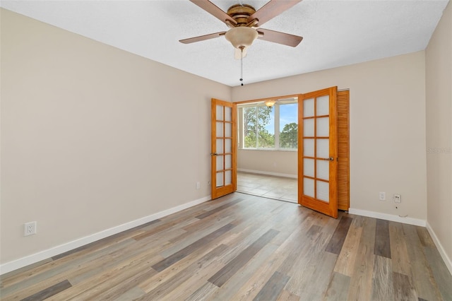 4885 1st St NE Unit 308, Saint Petersburg, FL 33703 - spare room featuring baseboards, a ceiling fan, and wood finished floors