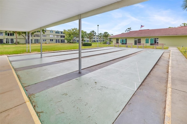 4885 1st St NE Unit 308, Saint Petersburg, FL 33703 - view of community featuring shuffleboard and a lawn