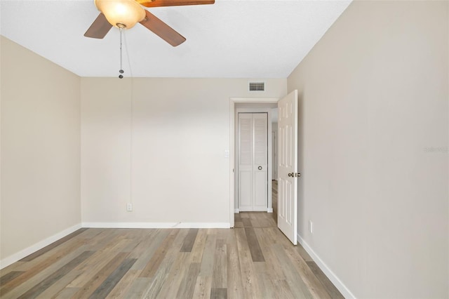 4885 1st St NE Unit 308, Saint Petersburg, FL 33703 - spare room featuring light wood-type flooring, baseboards, a ceiling fan, and visible vents