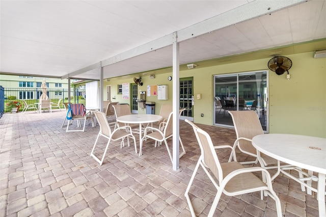 4885 1st St NE Unit 308, Saint Petersburg, FL 33703 - view of patio / terrace with fence and outdoor dining area