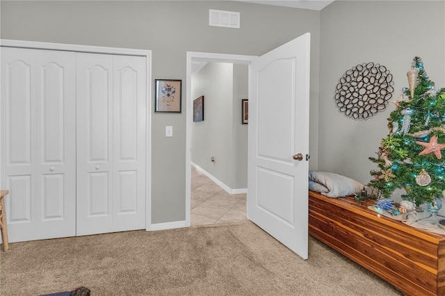 2918 130th Ave E, Parrish, FL 34219 - bedroom featuring light carpet, a closet, and light tile patterned flooring