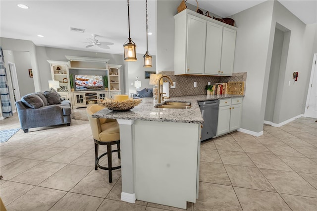 2918 130th Ave E, Parrish, FL 34219 - kitchen with dishwasher, a peninsula, light tile patterned flooring, light stone counters, and ceiling fan
