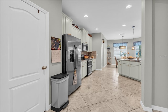 2918 130th Ave E, Parrish, FL 34219 - kitchen with appliances with stainless steel finishes, backsplash, hanging light fixtures, recessed lighting, and light tile patterned floors