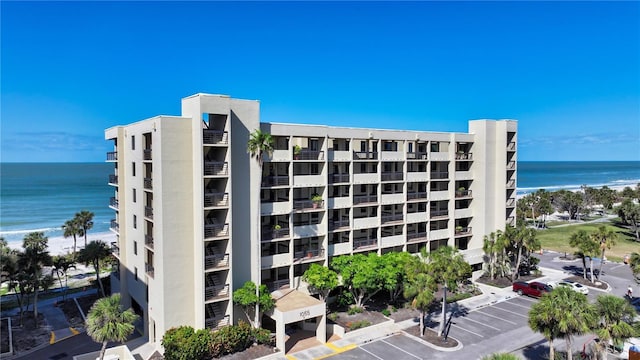 view of property with a water view and uncovered parking