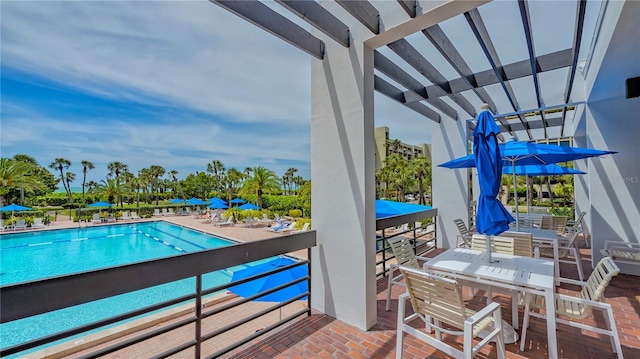 pool featuring outdoor dining space and a patio area