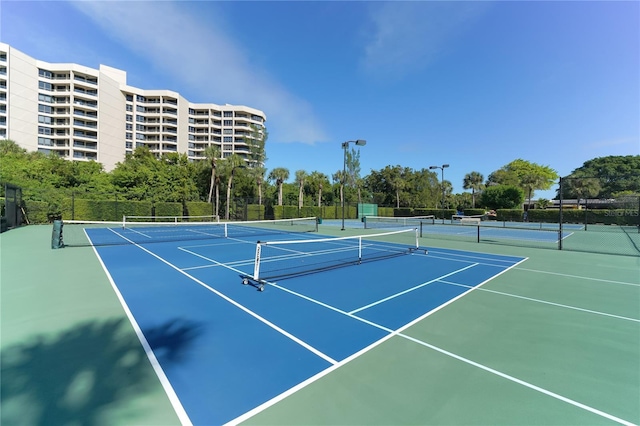view of sport court featuring community basketball court and fence