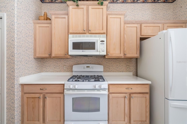 244 Dove Trl, Bradenton, FL 34212 - kitchen with white appliances, wallpapered walls, light brown cabinetry, and light countertops