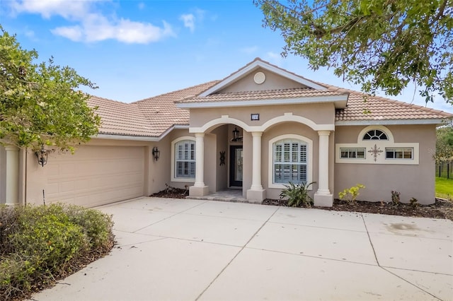 244 Dove Trl, Bradenton, FL 34212 - mediterranean / spanish home with stucco siding, driveway, a tile roof, and a garage