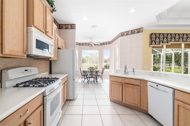 244 Dove Trl, Bradenton, FL 34212 - kitchen with white appliances, crown molding, wallpapered walls, light countertops, and light tile patterned flooring
