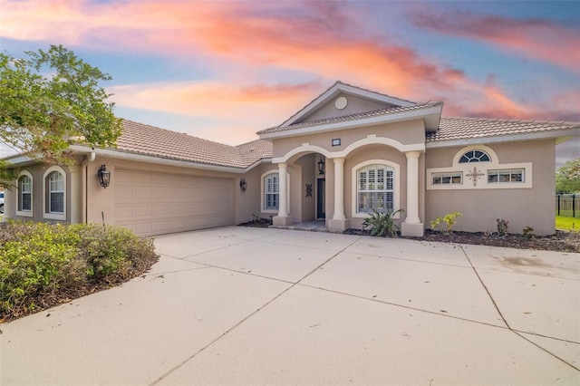 244 Dove Trl, Bradenton, FL 34212 - mediterranean / spanish house with stucco siding, a tile roof, concrete driveway, and a garage