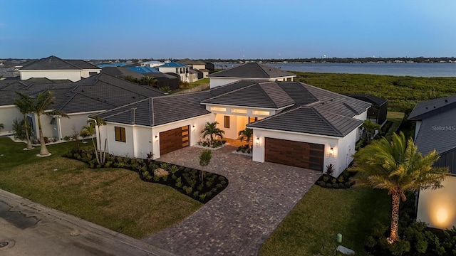 1613 4th St E, Palmetto, FL 34221 - view of front of property with a garage, stucco siding, decorative driveway, and a tile roof
