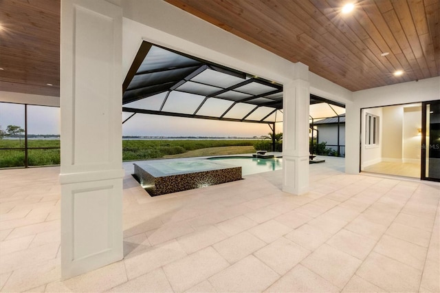 1613 4th St E, Palmetto, FL 34221 - view of patio / terrace featuring glass enclosure and a pool with connected hot tub