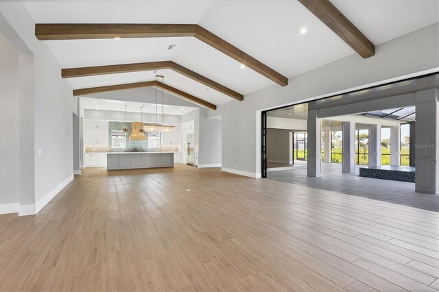 1613 4th St E, Palmetto, FL 34221 - unfurnished living room featuring light wood-style floors and baseboards