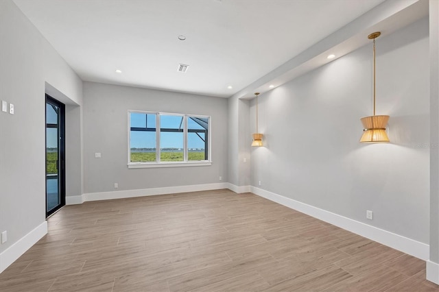 1613 4th St E, Palmetto, FL 34221 - spare room with wood finished floors, recessed lighting, and baseboards