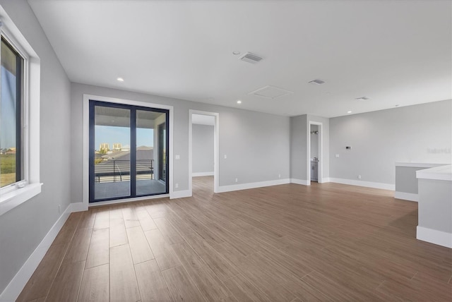 1613 4th St E, Palmetto, FL 34221 - empty room featuring wood finished floors, baseboards, and recessed lighting