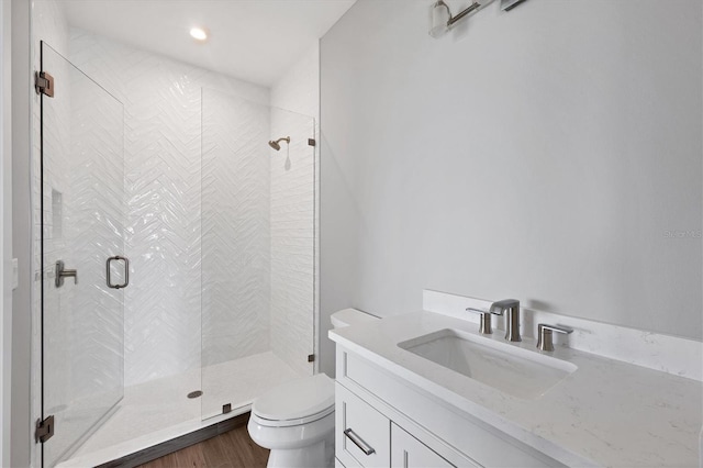 1613 4th St E, Palmetto, FL 34221 - full bathroom featuring toilet, a shower stall, vanity, and wood finished floors
