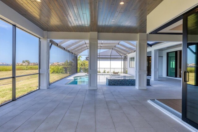 1613 4th St E, Palmetto, FL 34221 - view of swimming pool with a patio area, glass enclosure, and a pool with connected hot tub