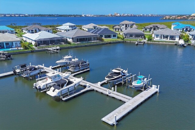 1613 4th St E, Palmetto, FL 34221 - dock featuring boat lift, a water view, and a residential view
