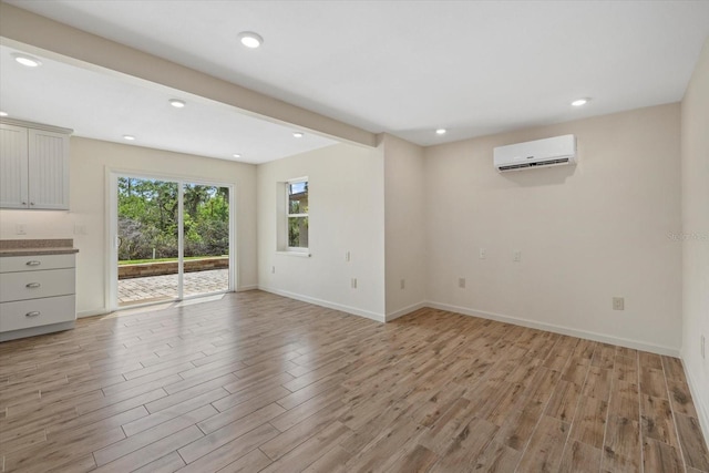 6718 68th Ave E, Bradenton, FL 34203 - unfurnished living room with light wood-style flooring, recessed lighting, baseboards, and a wall mounted air conditioner