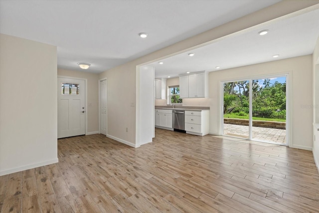 6718 68th Ave E, Bradenton, FL 34203 - unfurnished living room featuring recessed lighting, light wood-style floors, baseboards, and a sink