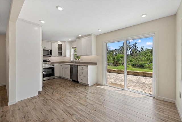 6718 68th Ave E, Bradenton, FL 34203 - kitchen with light wood-type flooring, recessed lighting, and stainless steel appliances